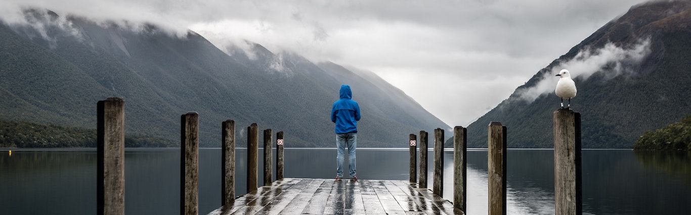 Person Stands Alone on Dock